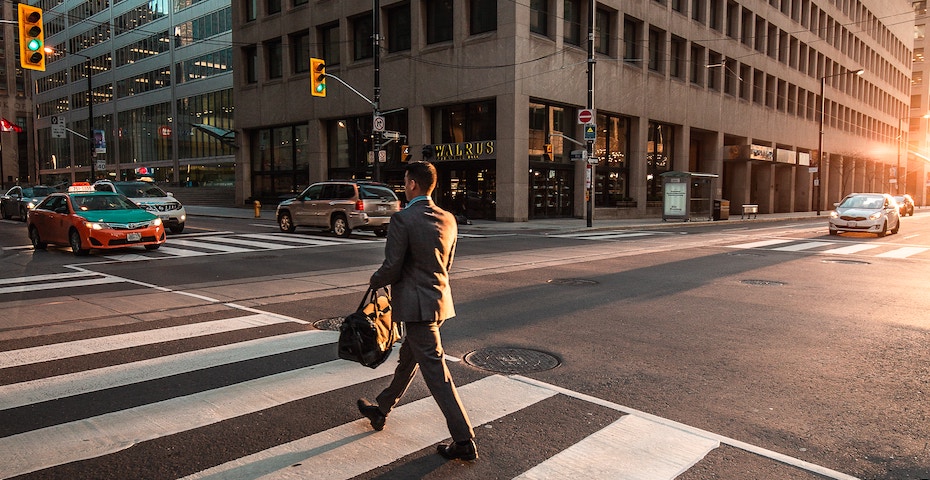 Business man crossing street