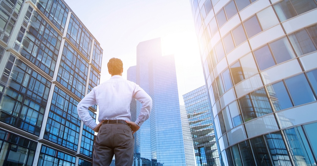 Man looking at commercial buildings